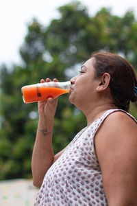 Midsection of man drinking glass