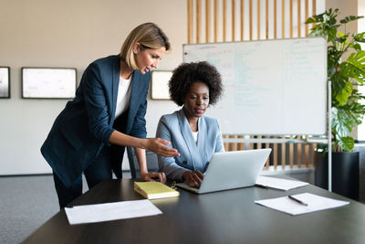 Diverse businesswomen using netbook together