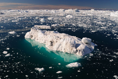 Aerial view of frozen sea against sky