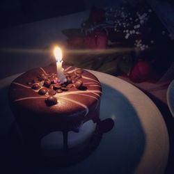 Lit candles on birthday cake