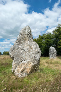 Rocks on field against sky