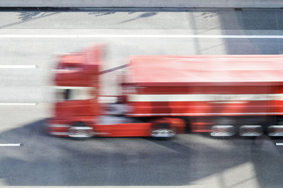 Blurred motion of man on road in city