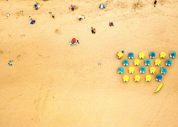 High angle view of multi colored umbrellas on sand at beach