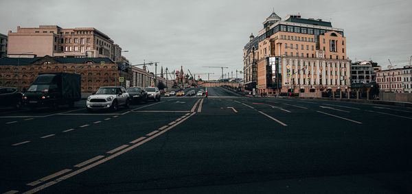 Vehicles on road against buildings in city