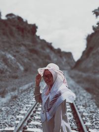 Rear view of woman standing on snow covered mountain