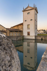 View of canal and buildings against sky