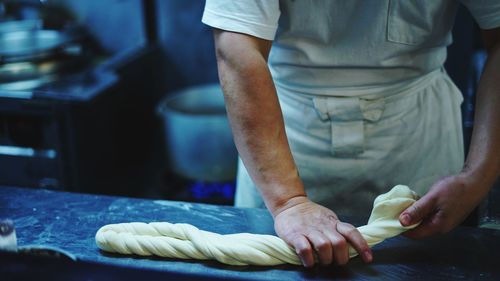 Midsection of man preparing food