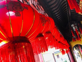 Low angle view of illuminated lanterns hanging in building