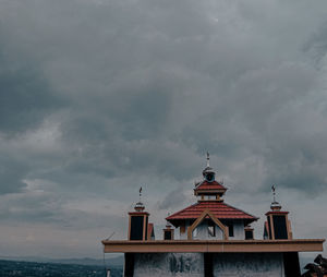 Low angle view of building against cloudy sky