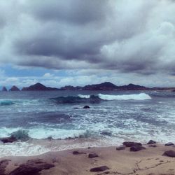 Scenic view of sea against cloudy sky