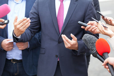 Midsection of woman using mobile phone