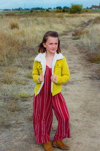 Portrait of a smiling girl standing outdoors