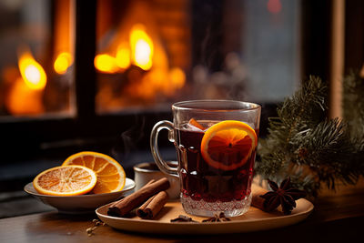 Cup of autumn or winter mulled wine or gluhwein with spices and orange slices