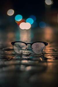 Close-up of illuminated lighting equipment on table at night