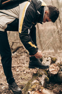 Man standing on field in forest