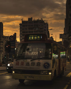 Cars on street in city at sunset