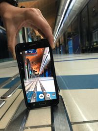 Man using mobile phone at railroad station