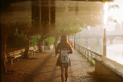 Woman walking on footpath