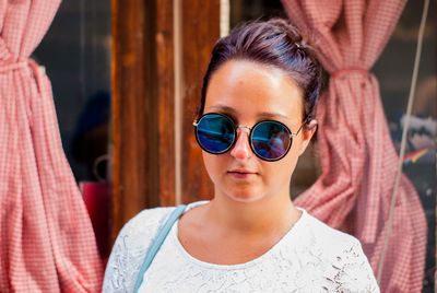 Close-up portrait of woman wearing sunglasses