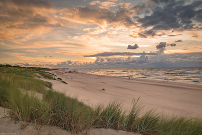 Scenic view of beach against sky during sunset