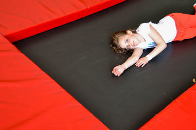 Happy sports girl having fun while jumping on trampoline