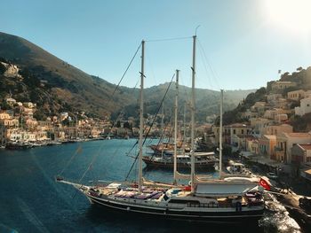 Sailboats moored at harbor