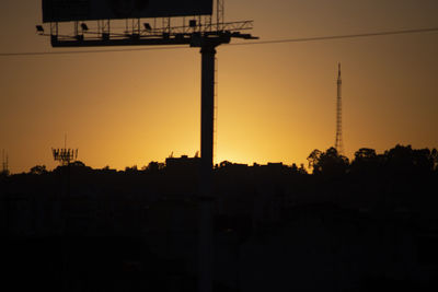 Silhouette buildings against sky during sunset