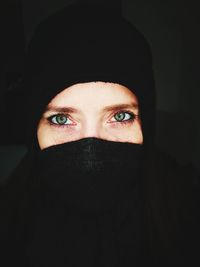 Close-up portrait of young woman covering face