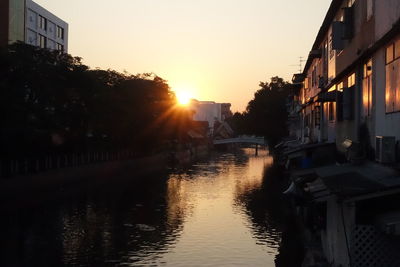Sunset over canal with buildings in background