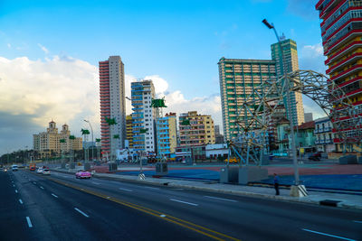 City street and modern buildings against sky