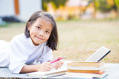 Portrait of a girl sitting on book