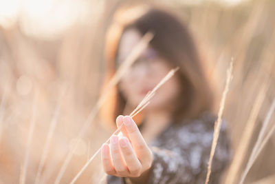 Close-up of woman holding leaf