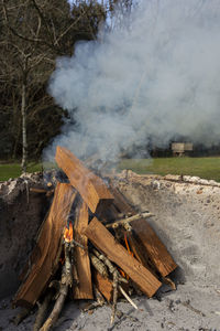 High angle view of bonfire on land against trees