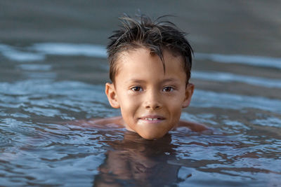 Portrait of boy swimming in lake