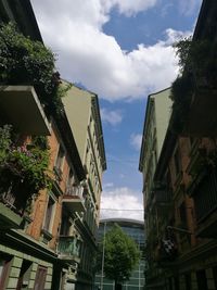 Low angle view of buildings in city against sky