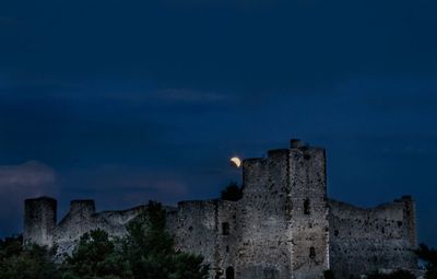 Low angle view of old building against sky at night