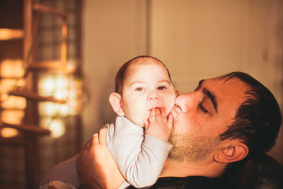 Portrait of man with baby at home