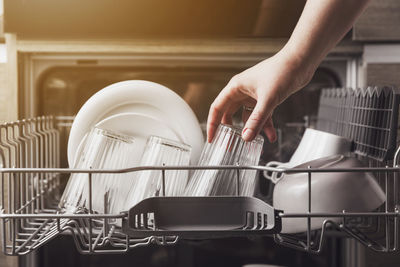 Cropped hand of man working in kitchen