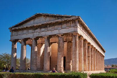 Low angle view of historical building against clear blue sky