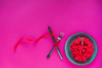 High angle view of pink rose on table