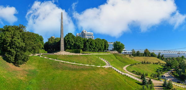 Panoramic view of trees on field against sky