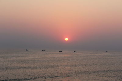 Scenic view of sea against clear sky during sunset