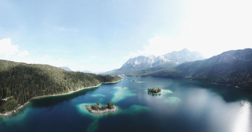 Scenic view of lake and mountains against sky