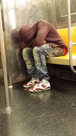 Low section of man sitting in bus