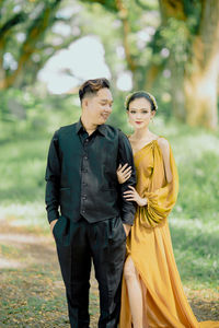 Portrait of smiling couple standing outdoors