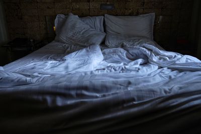 Crumpled sheet on bed at home