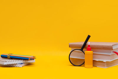 High angle view of equipment on yellow background