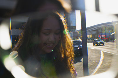 Smiling young woman seen through eyeglasses