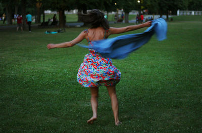 Rear view of woman on field