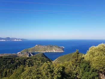 Scenic view of sea against clear blue sky